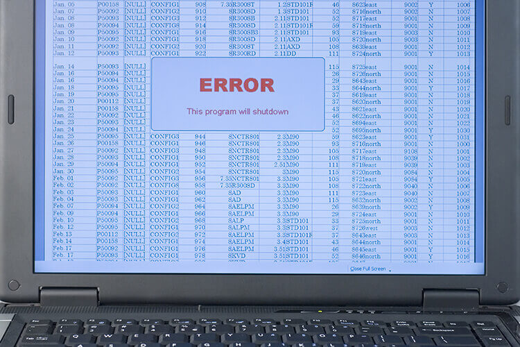 spreadsheet on laptop screen, with large error message
